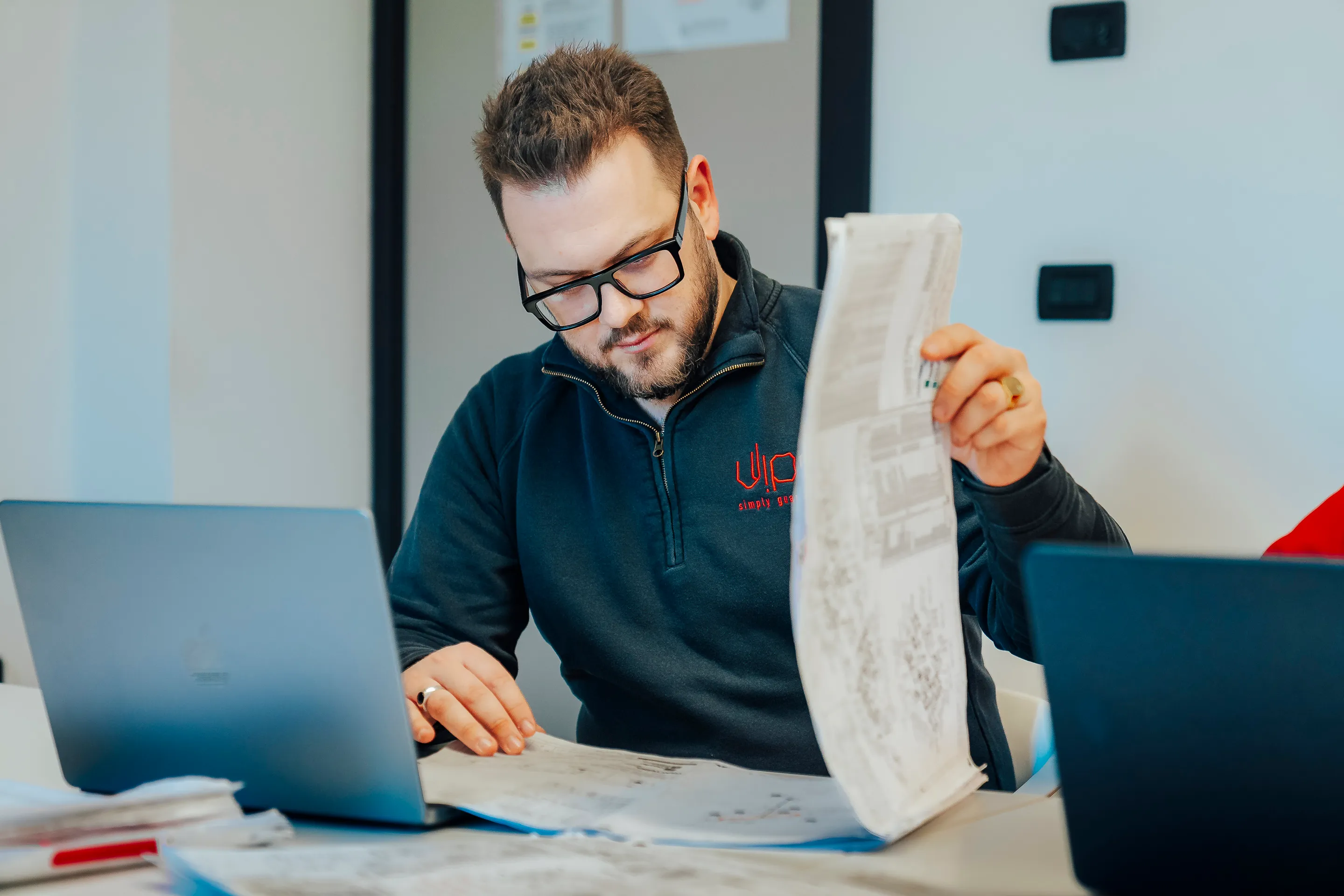 An oil and gas supervisor working with drawings and pc